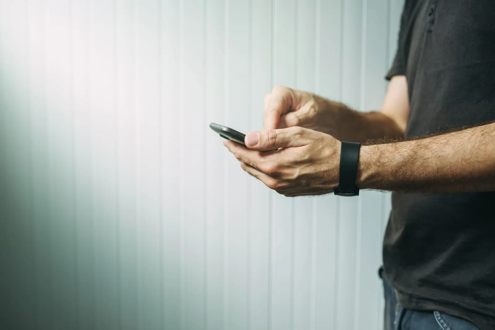 A person typing a text message on a mobile phone